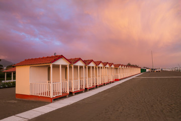 Forte dei Marmi's beach cabin in a purple sky sunset