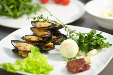 ingredients on the plate: mussels, onions, garlic, herbs