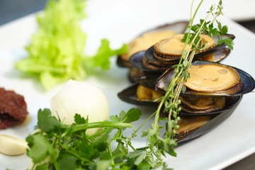 ingredients on the plate: mussels, onions, garlic, herbs