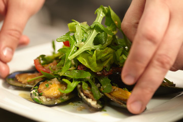 salad with mussels on a white plate