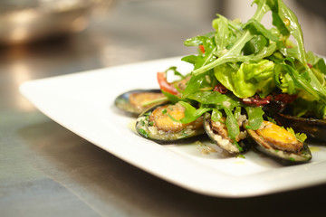salad with mussels on a white plate