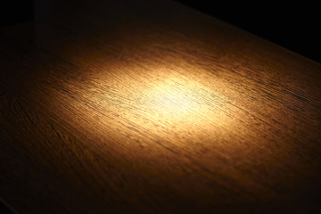 spot light on wooden surface