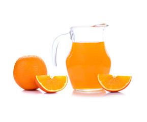 Orange juice in pitcher with orange. Isolated on white backgroun