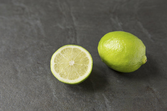 Fresh lime on slate background