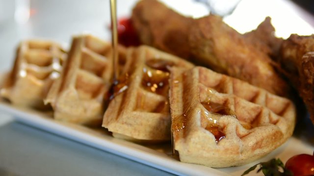 Pouring syrup on a waffle, shallow depth of field
