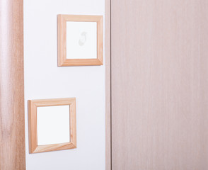 Empty wooden frames on a white wall, add your text or image