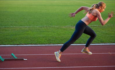 woman  sprinter leaving starting blocks