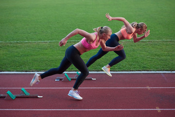 athlete woman group  running on athletics race track