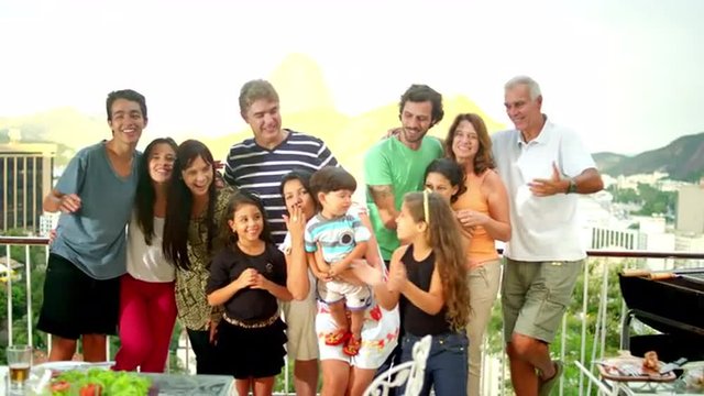 Family posing for a portrait at a Brazilian family BBQ