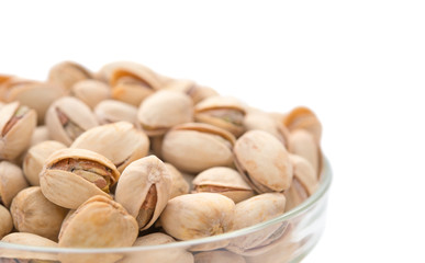 Pistachio nuts in a glass bowl close up with clipping path