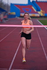 Fototapeta na wymiar sporty woman on athletic race track