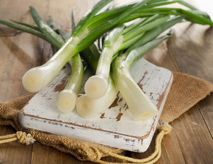 Fresh Green onion on   wooden cutting board.