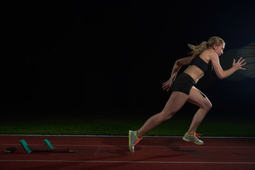 woman  sprinter leaving starting blocks