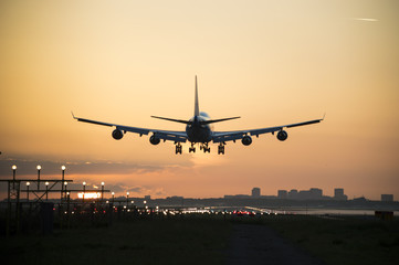 Fototapeta na wymiar Airplane during landing in the early morning.