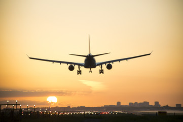 Fototapeta na wymiar Silhouette from an airplane, photo taken during sunrise.