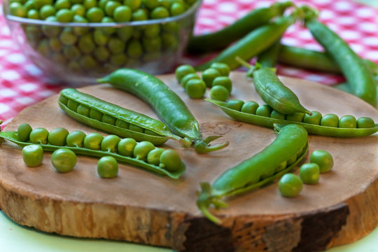 Peas pods on wooden board