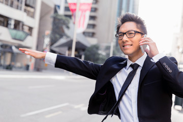 Waving for a taxi in city