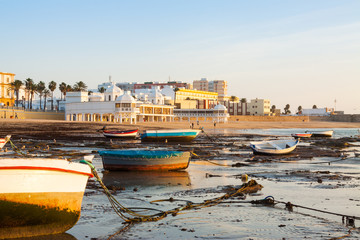 sunrise view from Playa de la Caleta with boats © JackF