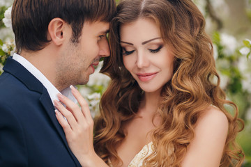 The bride and groom - photo in a flowery Park in the spring.