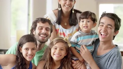 Family smiles in a living room