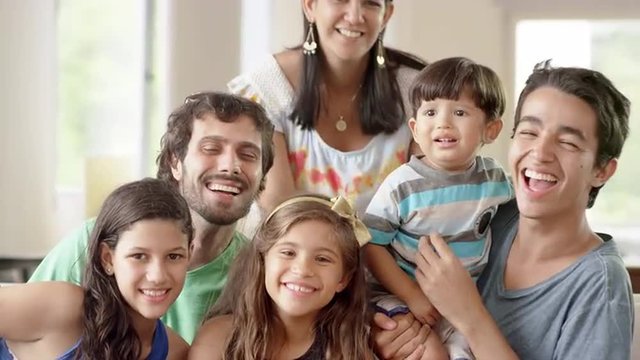 Family smiles in a living room