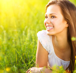 Beauty romantic girl lying on summer field