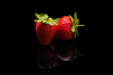 Concept of strawberries in water drops on dark background