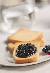 Delicious toast with jam on table close-up