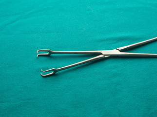 a pair of stainless steel surgical forceps