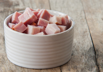 Bacon close up in bowl on wooden background © Adriana Nikolova