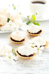 Obraz na płótnie Canvas French meringue cookies in tartlet on white wooden background