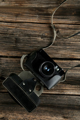 Old retro camera on brown wooden background