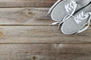 Pair of grey shoes on wooden background