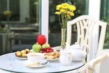 tea time with chocolate and cookies or biscuit and fruit