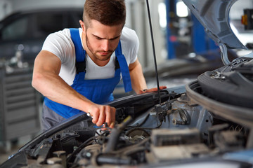 Fototapeta na wymiar Car Mechanic Working With Engine. Auto Repair Shop