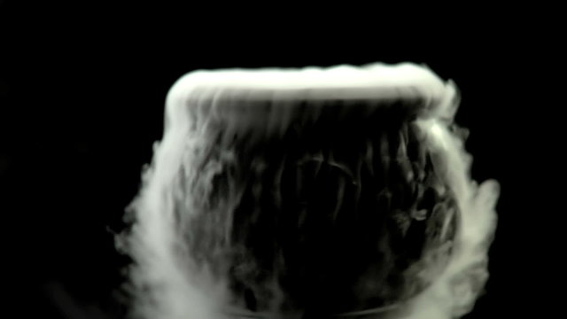 A Cauldron steams on a black background