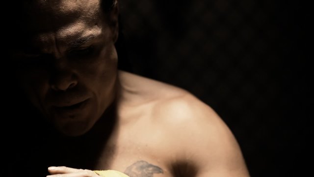 Native American mixed martial arts hits his hands and intimidates the camera