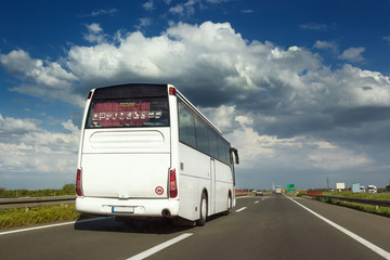 White bus is done overtaking on the highway