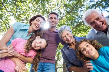 Extended family smiling in the park