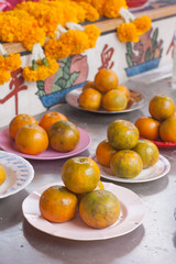 Orange on dish in chinese shrine for making merit.