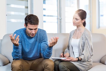 Psychologist talking with depressed man