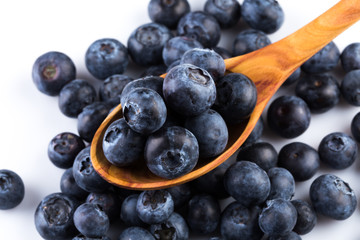 Fresh blueberries in wooden spoon