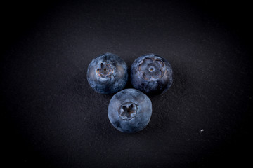 Blueberries on stone plate background