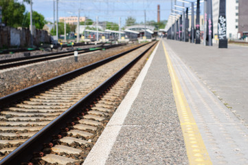 Obraz na płótnie Canvas Young man waits train on railway station