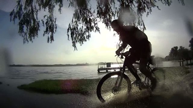 Bike ride in rainy sunset, slow motion