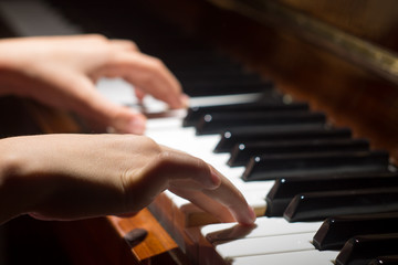 Fototapeta na wymiar Playing on piano keyboard