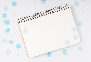 Blank notepad with elegancy paper snowflakes around