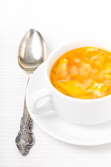 Ceramic bowl with soup served on the table. 