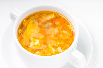 White bowl with vegetable soup.