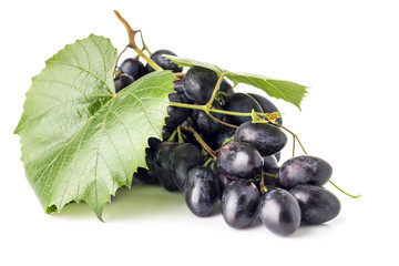Bunch of grapes with leaves isolated on white background